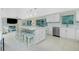 Eat-in kitchen featuring stainless appliances, white cabinets and a large island with seating at 52 Golfview Ter, Rotonda West, FL 33947