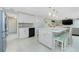Eat-in kitchen featuring stainless appliances, white cabinets and a large island with seating at 52 Golfview Ter, Rotonda West, FL 33947