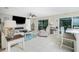 Cozy living room featuring tile floors, ceiling fan, fireplace, and sliding glass doors at 52 Golfview Ter, Rotonda West, FL 33947