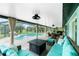 Screened-in patio with comfortable seating, dining area and pool in background at 52 Golfview Ter, Rotonda West, FL 33947
