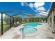 A screened-in pool area features a kidney shaped pool and stone patio at 52 Golfview Ter, Rotonda West, FL 33947