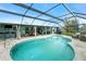 Screened in pool with an attached spa and an outdoor kitchen and bar area for entertaining at 52 Golfview Ter, Rotonda West, FL 33947