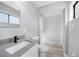 Modern bathroom features white vanity, matte black faucet, and tiled walk-in shower at 5881 Talbrook Rd, North Port, FL 34287