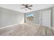 Bright living room with a ceiling fan, and updated floors with view of front yard at 5881 Talbrook Rd, North Port, FL 34287