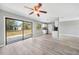Open living room featuring modern finishes, sliding door access, and a ceiling fan at 5881 Talbrook Rd, North Port, FL 34287