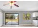 Open living room with sliding glass doors to backyard and view of the kitchen area at 5881 Talbrook Rd, North Port, FL 34287
