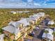 Aerial view of bright condominiums with convenient parking and lush landscaping at 6610 Gasparilla Pines Blvd # 111, Englewood, FL 34224