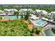 Aerial view of the community featuring a pool, pickleball courts, tropical landscaping and inviting common areas at 6610 Gasparilla Pines Blvd # 111, Englewood, FL 34224