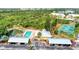 Aerial view of community featuring a pool, a pickleball court, parking and beautiful landscaping in a tranquil location at 6610 Gasparilla Pines Blvd # 111, Englewood, FL 34224