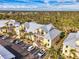 Aerial view of bright condominiums with convenient parking and lush landscaping at 6610 Gasparilla Pines Blvd # 111, Englewood, FL 34224