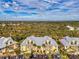 Aerial view of bright condominiums with convenient parking and lush landscaping at 6610 Gasparilla Pines Blvd # 111, Englewood, FL 34224
