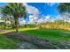 Beautiful backyard with lush greenery, picturesque palm trees, and natural landscaping in a peaceful setting at 6610 Gasparilla Pines Blvd # 111, Englewood, FL 34224