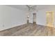 Bedroom featuring white walls, ceiling fan, wood-look floors, and a view to a bathroom at 6610 Gasparilla Pines Blvd # 111, Englewood, FL 34224