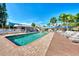 Inviting community pool with ample lounge chairs, perfect for relaxation and socializing in a tropical setting at 6610 Gasparilla Pines Blvd # 111, Englewood, FL 34224