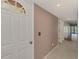 Hallway with light taupe walls, white trim, and white six panel doors at 6610 Gasparilla Pines Blvd # 111, Englewood, FL 34224