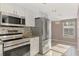 Kitchen featuring stainless steel appliances, a tile backsplash, and granite countertops at 6610 Gasparilla Pines Blvd # 111, Englewood, FL 34224