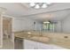 Bright kitchen features granite countertops, stainless steel dishwasher, and flows to the bathroom at 6610 Gasparilla Pines Blvd # 111, Englewood, FL 34224