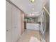 Bright kitchen has recessed lights, tile floor, stainless steel refrigerator and flows to other rooms at 6610 Gasparilla Pines Blvd # 111, Englewood, FL 34224