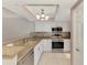 Bright kitchen with granite counters, stainless appliances, and tile flooring at 6610 Gasparilla Pines Blvd # 111, Englewood, FL 34224