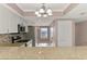 Bright kitchen features granite countertops, stainless steel appliances and adjacent breakfast bar at 6610 Gasparilla Pines Blvd # 111, Englewood, FL 34224