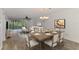 Bright living room featuring a dining table and an open floor plan leading to the outdoor area at 6610 Gasparilla Pines Blvd # 111, Englewood, FL 34224