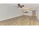 Spacious living room featuring hardwood style floors and ceiling fan at 6610 Gasparilla Pines Blvd # 111, Englewood, FL 34224