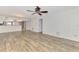 Living room featuring hardwood flooring, a ceiling fan, with view of the breakfast bar at 6610 Gasparilla Pines Blvd # 111, Englewood, FL 34224