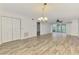 Spacious living room with access to a screened lanai and hardwood-style floors at 6610 Gasparilla Pines Blvd # 111, Englewood, FL 34224