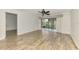 Living room with hardwood-style floors and access to the screened patio at 6610 Gasparilla Pines Blvd # 111, Englewood, FL 34224