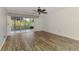 Living room featuring hardwood style floors and access to the screened patio at 6610 Gasparilla Pines Blvd # 111, Englewood, FL 34224