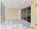 Open patio with tile floor and access to outdoor living space at 6610 Gasparilla Pines Blvd # 111, Englewood, FL 34224
