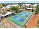Overhead view of well-maintained community pickleball courts in a charming neighborhood setting, perfect for recreation at 6610 Gasparilla Pines Blvd # 111, Englewood, FL 34224