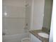 Bathroom featuring a tiled shower/bathtub and granite countertop sink at 6998 Dabarsky Ave, North Port, FL 34291