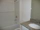 Bathroom with white subway tile shower and granite vanity at 6998 Dabarsky Ave, North Port, FL 34291