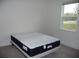 Bedroom with plush carpet, large window, and neutral walls at 6998 Dabarsky Ave, North Port, FL 34291