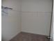 Walk-in closet featuring a rack and neutral carpet at 6998 Dabarsky Ave, North Port, FL 34291