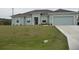 Charming single-story home with a well-maintained lawn and attached two-car garage at 6998 Dabarsky Ave, North Port, FL 34291