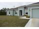 Charming one-story home with an attached two-car garage and a well-manicured lawn at 6998 Dabarsky Ave, North Port, FL 34291