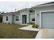 Charming single-story home featuring a well-maintained lawn and a two-car garage at 6998 Dabarsky Ave, North Port, FL 34291