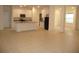 Open concept kitchen with granite countertops, white cabinets, and stainless steel appliances at 6998 Dabarsky Ave, North Port, FL 34291