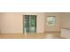 Bright living room featuring sliding glass doors and tile flooring throughout the area at 6998 Dabarsky Ave, North Port, FL 34291