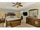 Comfortable main bedroom features a ceiling fan, a large bed, and an ensuite bathroom with a tub at 7027 Mineola Rd, Englewood, FL 34224