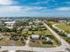 Aerial view showing the home's neighborhood and location near the water, trees, and other homes at 7032 Duke St, Englewood, FL 34224