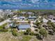 High angle view of the home, its yard and the neighborhood including palm trees and other homes at 7032 Duke St, Englewood, FL 34224