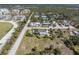 High-angle image displaying the property, the surrounding neighborhood, and the community in the distance at 7032 Duke St, Englewood, FL 34224