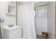 Bathroom with white tiling and matching shower curtain at 7032 Duke St, Englewood, FL 34224