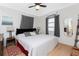 Bedroom with a ceiling fan, side tables and wooden floors at 7032 Duke St, Englewood, FL 34224