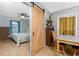 View of a charming bedroom with a sliding barn door at 7032 Duke St, Englewood, FL 34224