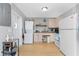 Efficient kitchen with essential appliances and convenient washer/dryer setup at 7032 Duke St, Englewood, FL 34224