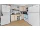 Efficient kitchen with essential appliances and convenient washer/dryer setup at 7032 Duke St, Englewood, FL 34224